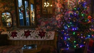 a room with a christmas tree and a mirror