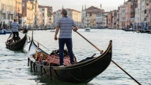 a man standing on a boat in the water