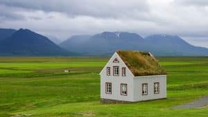 a white house in a green field