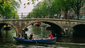 people riding on blue boat on river during daytime
