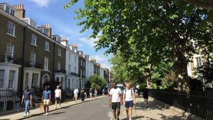 People walking on a sunny street near Wimbledon.
