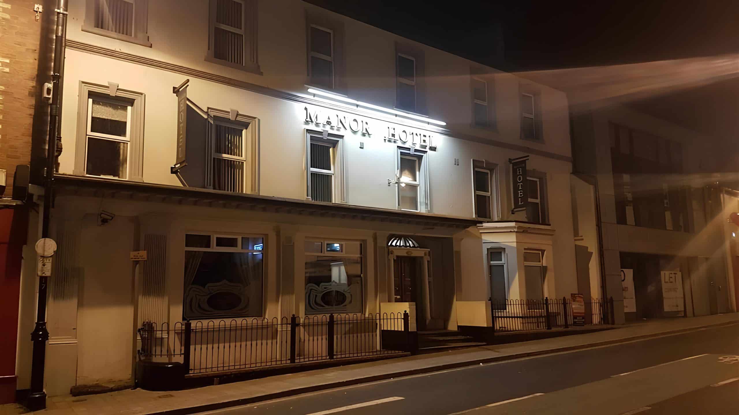 Burgundy and cream Main Street facade of Manor Hotel Ballymoney with traditional pub-front signage, County Antrim
