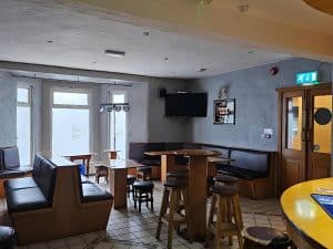 Bar with tables and stools at Manor Hotel Ballymoney