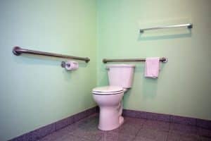 Private bathroom at National 9 Motel in Santa Cruz with mint-green walls and grab bars
