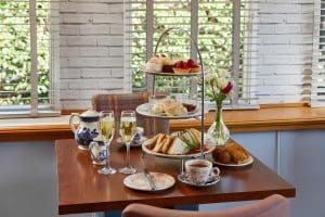 Plates of food and glasses of wine on a table at Cook's Bar and Kitchen, The Grange Manor in Grangemouth