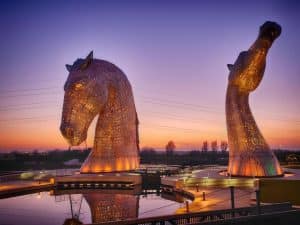 The Kelpies sculptures lit up at sunset, a 13-minute walk from The Grange Manor in Grangemouth