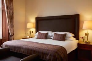 Executive King Room at The Grange Manor with a large bed and luxurious pillows, Grangemouth