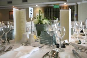 Restaurant table at The Grange Manor laid with wine glasses and silverware, Grangemouth