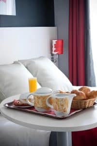Continental breakfast at Hotel Berkeley Paris, pastries, bread with jam and honey, orange juice and hot drinks