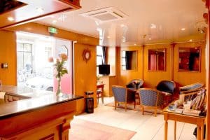 Hotel Berkeley reception and lobby in Paris, a small 24-hour front desk in an independent Montparnasse 3-star hotel