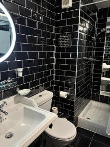 Private en-suite bathroom at Keats Green Hotel with bath, shower and free toiletries