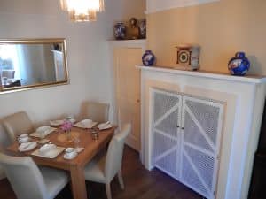 Traditional breakfast room at The Rutlands B&B set for a full English on china