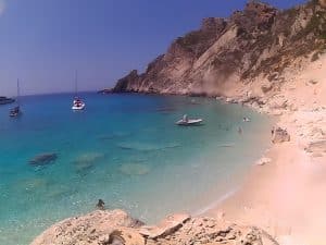 The sandy town beach of Ammos with calm shallow water on the edge of Agios Nikolaos, Crete