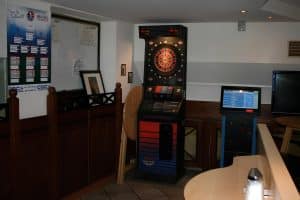 The downstairs games-room bar with a billiards table and green pendant lamps at Hostel Bad Goisern