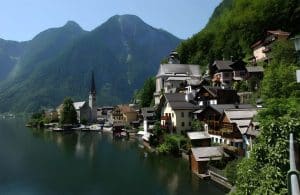 The lakeside village of Hallstatt with its church spire and pastel houses reflected in the Hallstättersee