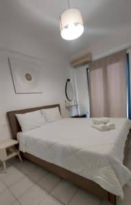 Sea-view apartment at Pergola Hotel with a double bed, sofa and a balcony overlooking the bay, Agios Nikolaos