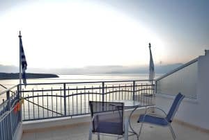 Self-catering studio at Pergola Hotel with a kitchenette, dining table and a balcony door, Agios Nikolaos