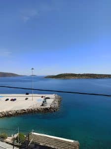 Daytime view over Mirabello Bay and the harbour breakwater with a small island beyond, Agios Nikolaos