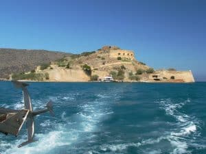 The fortified teardrop island of Spinalonga rising from the sea off the coast of eastern Crete