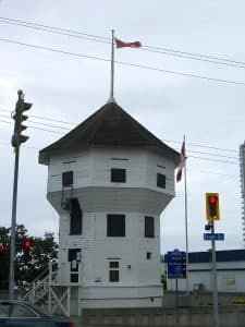 The Bastion in Nanaimo, a white octagonal wooden fort built by the Hudson's Bay Company, standing on Front Street with a flag flying from its roof