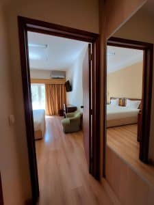 A doorway at the Petrus Hotel looking through to a room with a seating area beyond