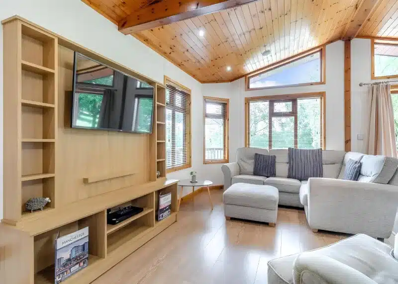 a living room with a couch and a tv at Charlesworth Lodges in Glossop