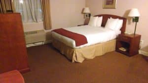 A made-up hotel bedroom, the room a damage claim would be about