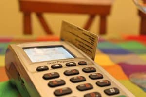 A card payment terminal with a bank card inserted, mid-transaction