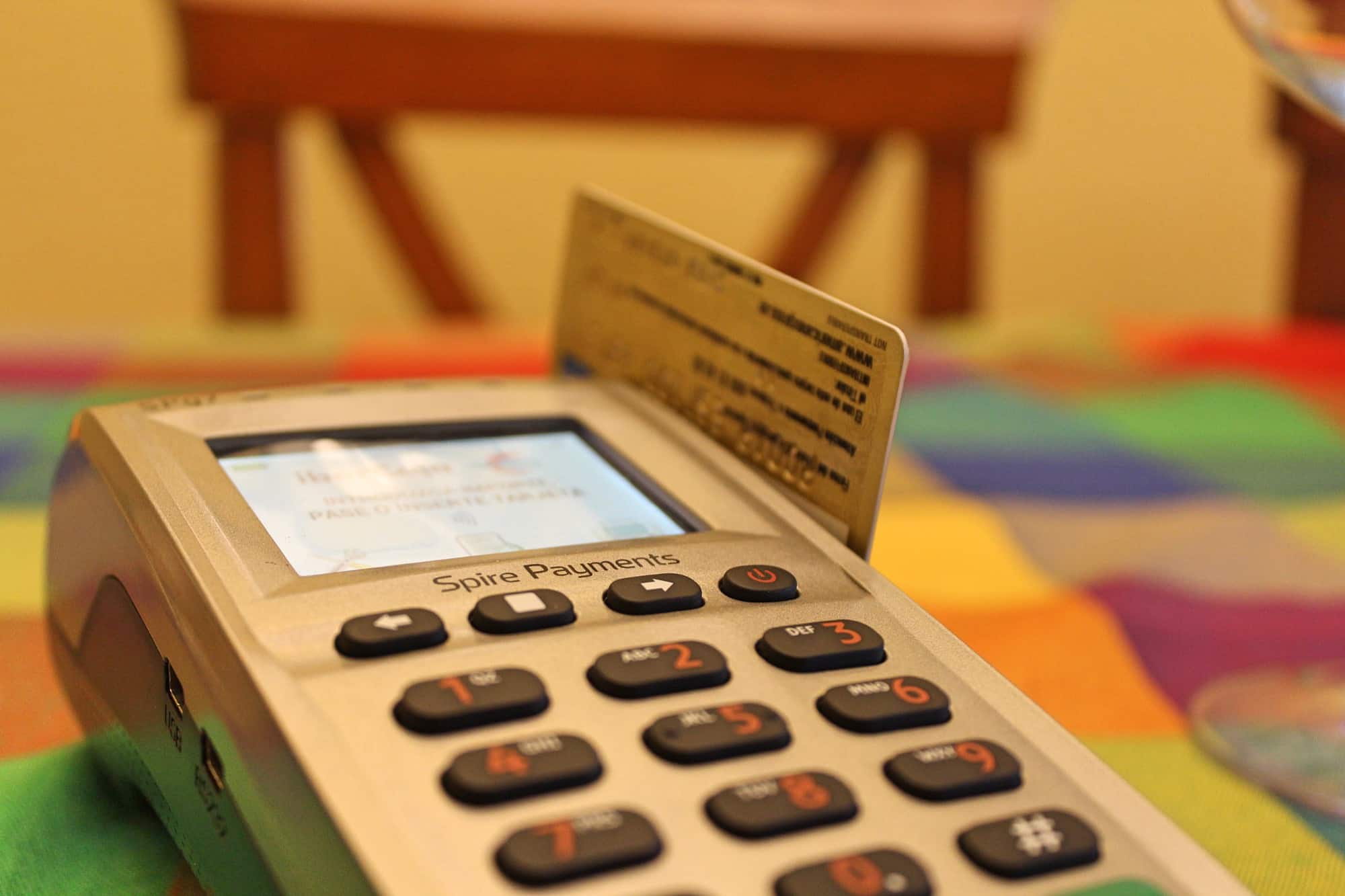 A card payment terminal with a bank card inserted, mid-transaction