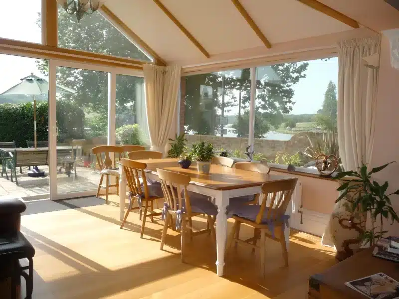 Breakfast tables in Ivy Hall’s sunroom overlooking the patio