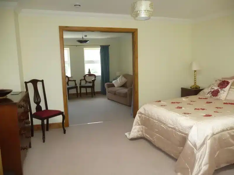 Junior Suite bedroom opening into its separate sitting room