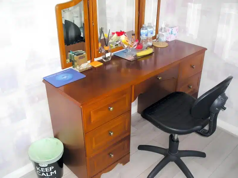 The wooden desk and black office chair in the room at Liverpool Airport Rooms.