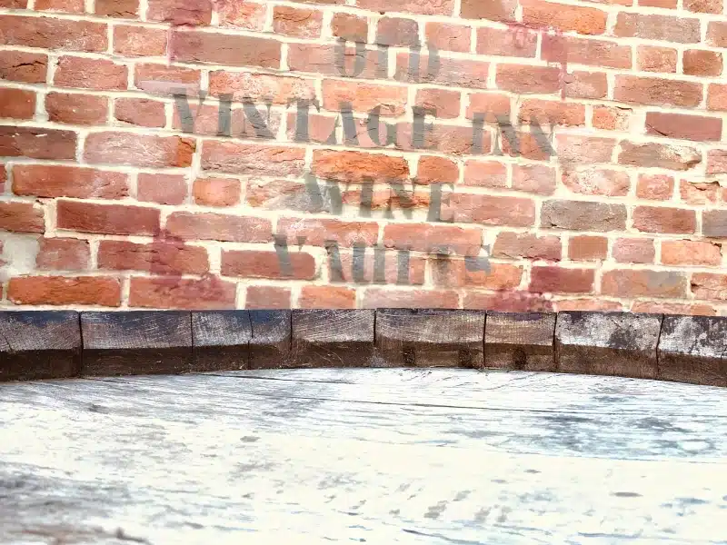 A brick wall inside the inn, painted with the words Old Vintage Inn Wine Vaults.