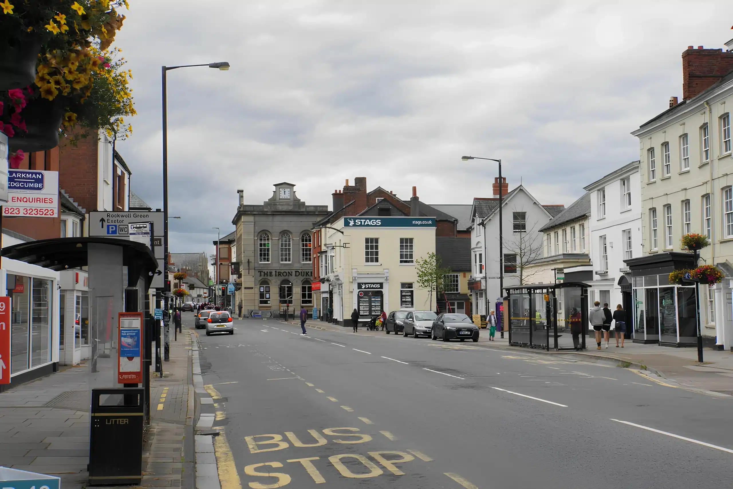 High Street in Wellington, Somerset, looking towards the Iron Duke, with a bus stop in the foreground.