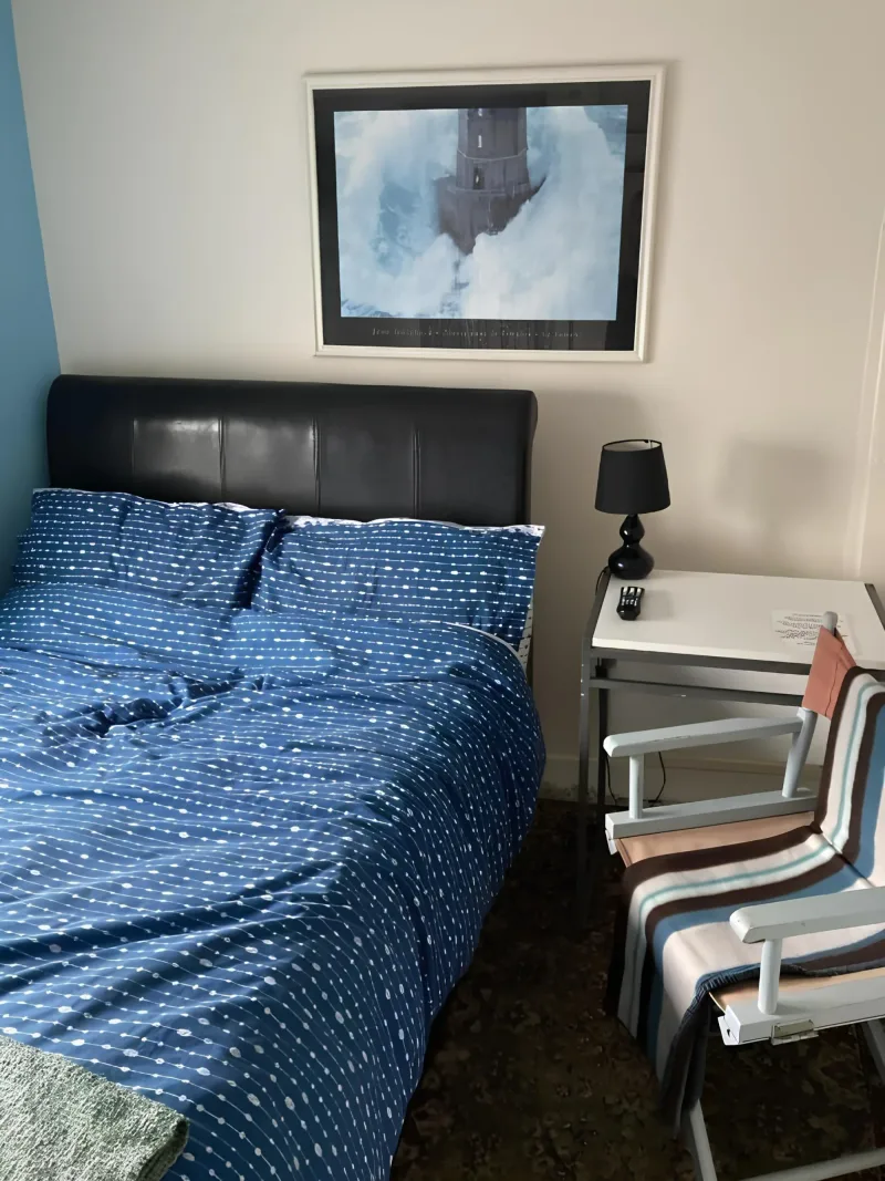 Blue bedspread and wooden headboard in a bedroom