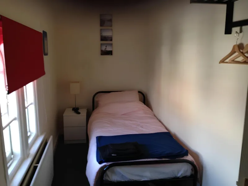 Single bed beside a window in the Economy room