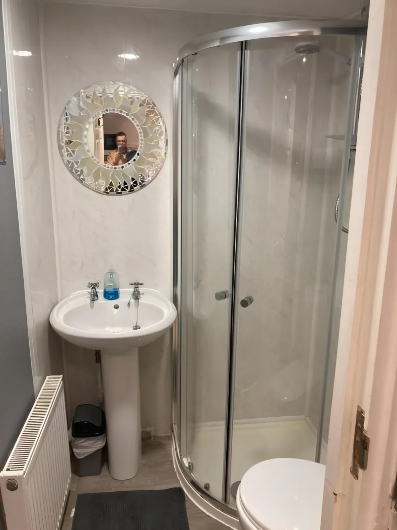 Compact shower enclosure and basin