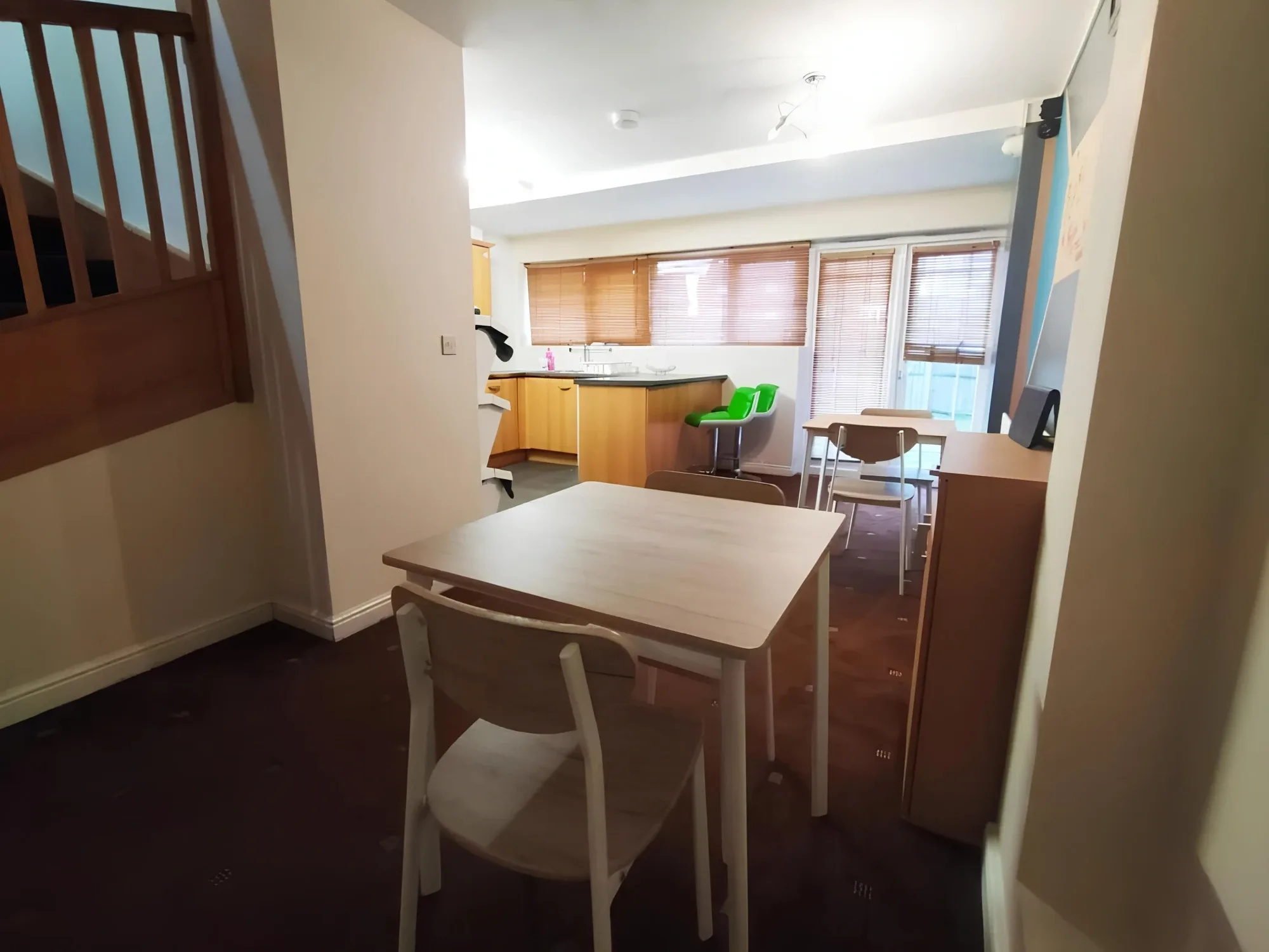 Kitchen and dining area with tables and chairs at Bankwell Guest House