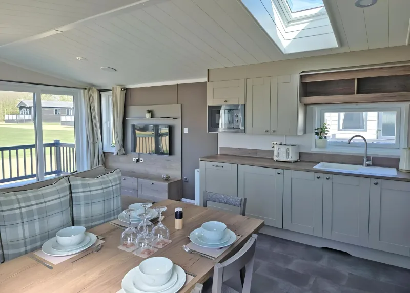 Two-Bedroom Chalet kitchen and dining area with checked seating and a skylight