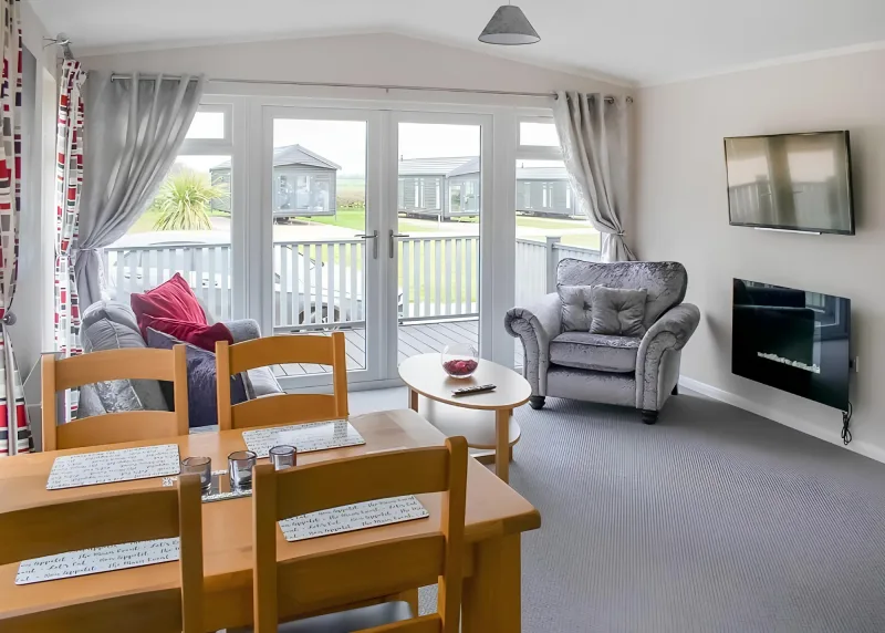 Two-Bedroom House living and dining area with grey seating and red cushions