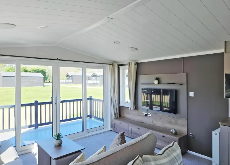 Open-plan lodge living area with blue seating