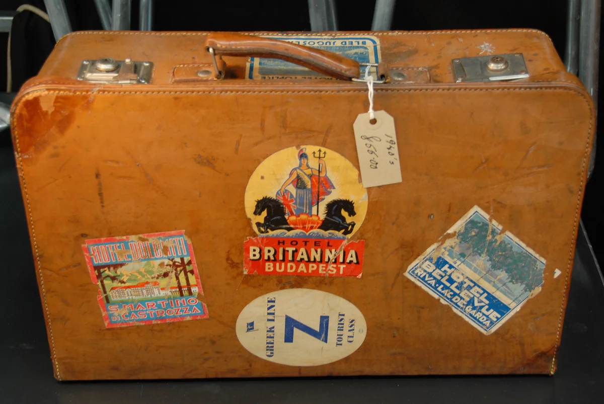 A suitcase covered with luggage labels