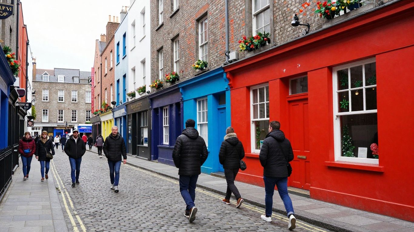 Pedestrians on a Dublin street beside colourful pub fronts